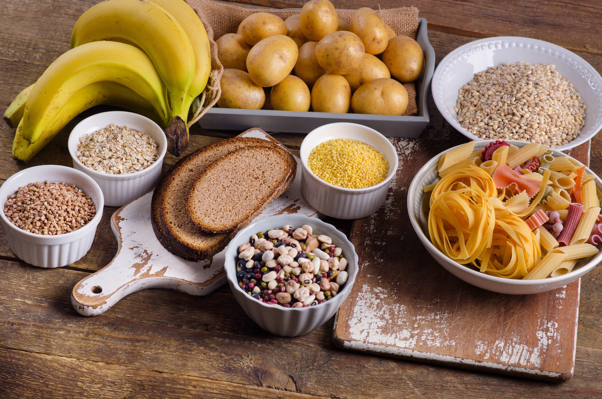 foods-high-in-carbohydrate-on-rustic-wooden-background-top-view